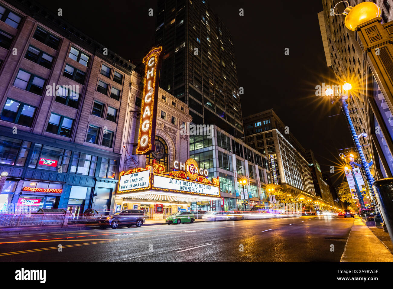 The iconic Chicago Theatre on a cold winter night with a long exposure of vehicles passing by on State Street. Stock Photo