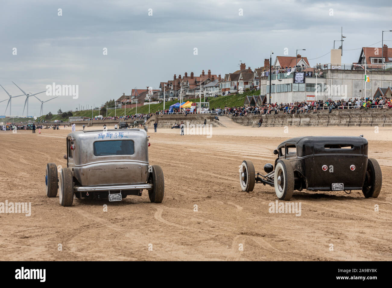 Two vintage hot rods line up at "Race the Waves" event, where cars and