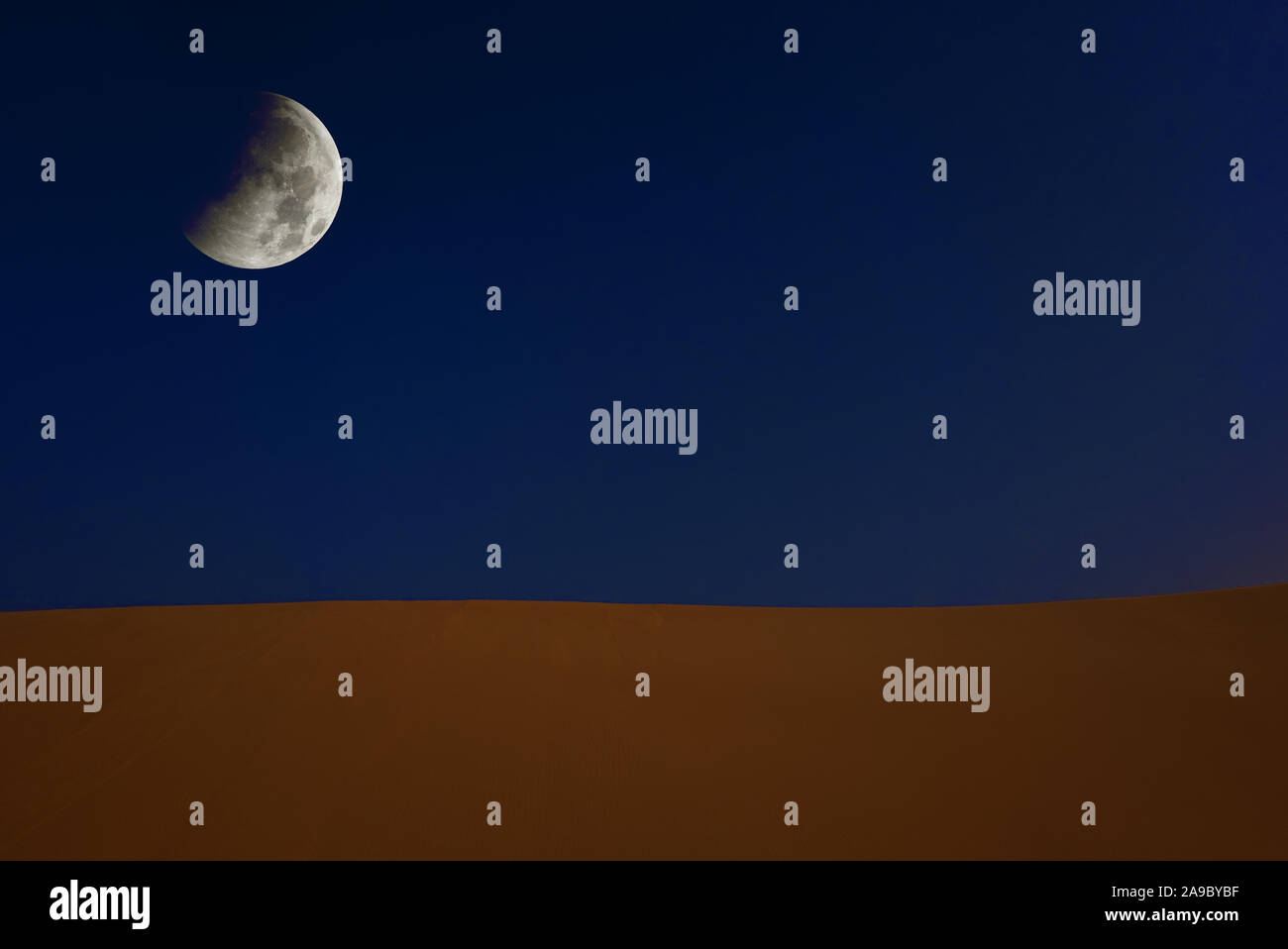 Abstract collage of a sand dune in the desert of Sudan with the moon at the dark sky. Elements of this image furnished by NASA Stock Photo