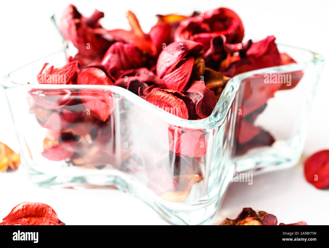 Closeup of Red Dried Floral Potpourri in Star Shaped Crystal Dish Stock Photo