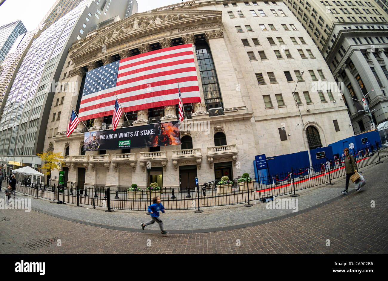 A giant American flag is unfurled across the facade of the New York Stock Exchange to commemorate Veterans Day in New York on Monday, November 11, 2019. Originally knows as Armistice Day, the holiday memorializes that on the eleventh hour of the eleventh day of the eleventh month the guns fell silent in1918 marking the end of World War I.  The holiday has since been expanded to include all American soldiers from all wars.(© Richard B. Levine) Stock Photo