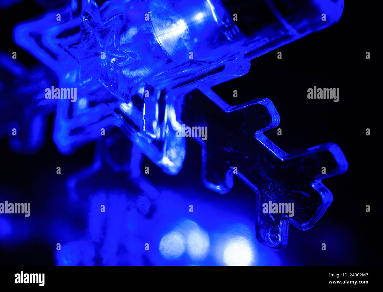 Closeup of Single Blue Glowing Snowflake Led Light Stock Photo