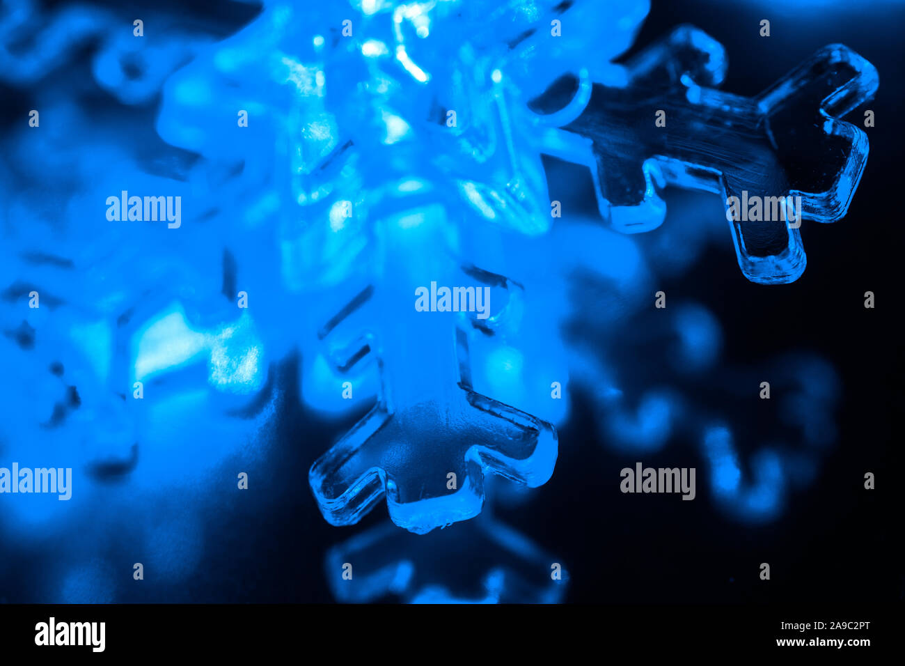 Closeup of Illuminated Blue Snowflake Led Light Stock Photo