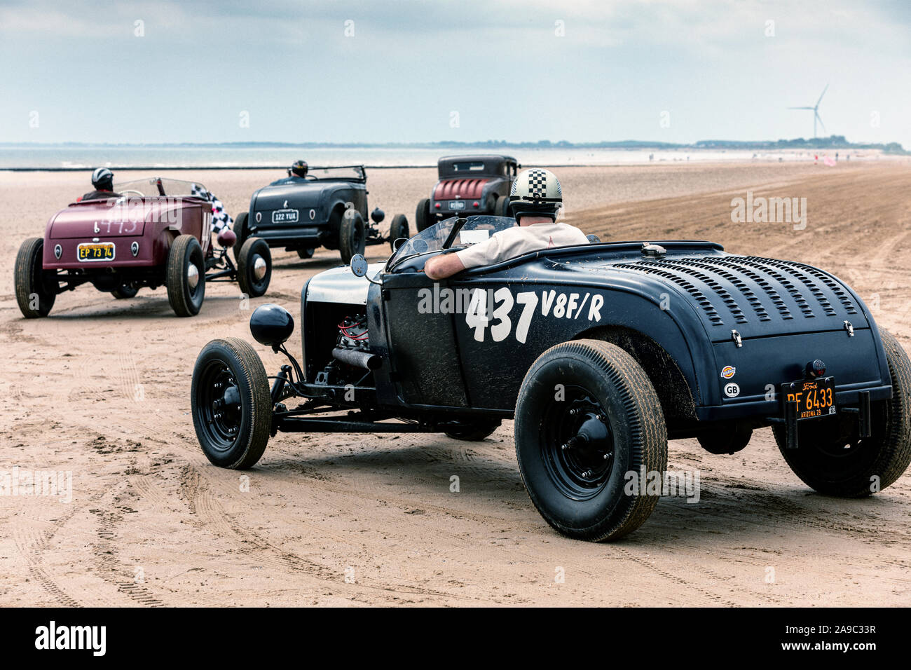 Vintage hot rods line up at the 'Race the Waves' event, where cars and motorcycles drag race on the beach at Bridlington, East Yorkshire England UK Stock Photo