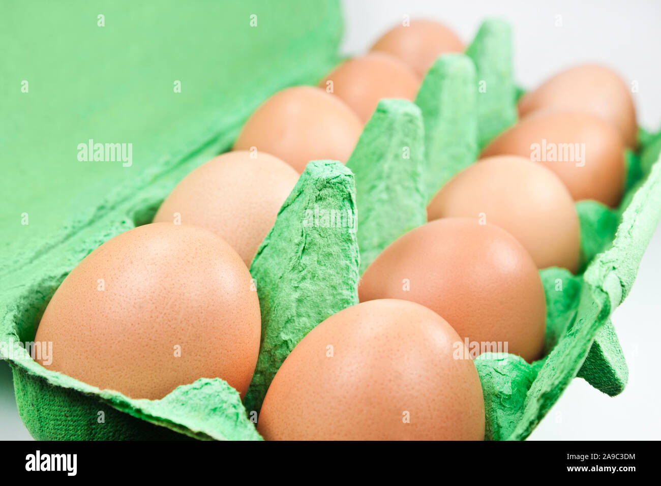 Ten brown eggs in egg box close up Stock Photo