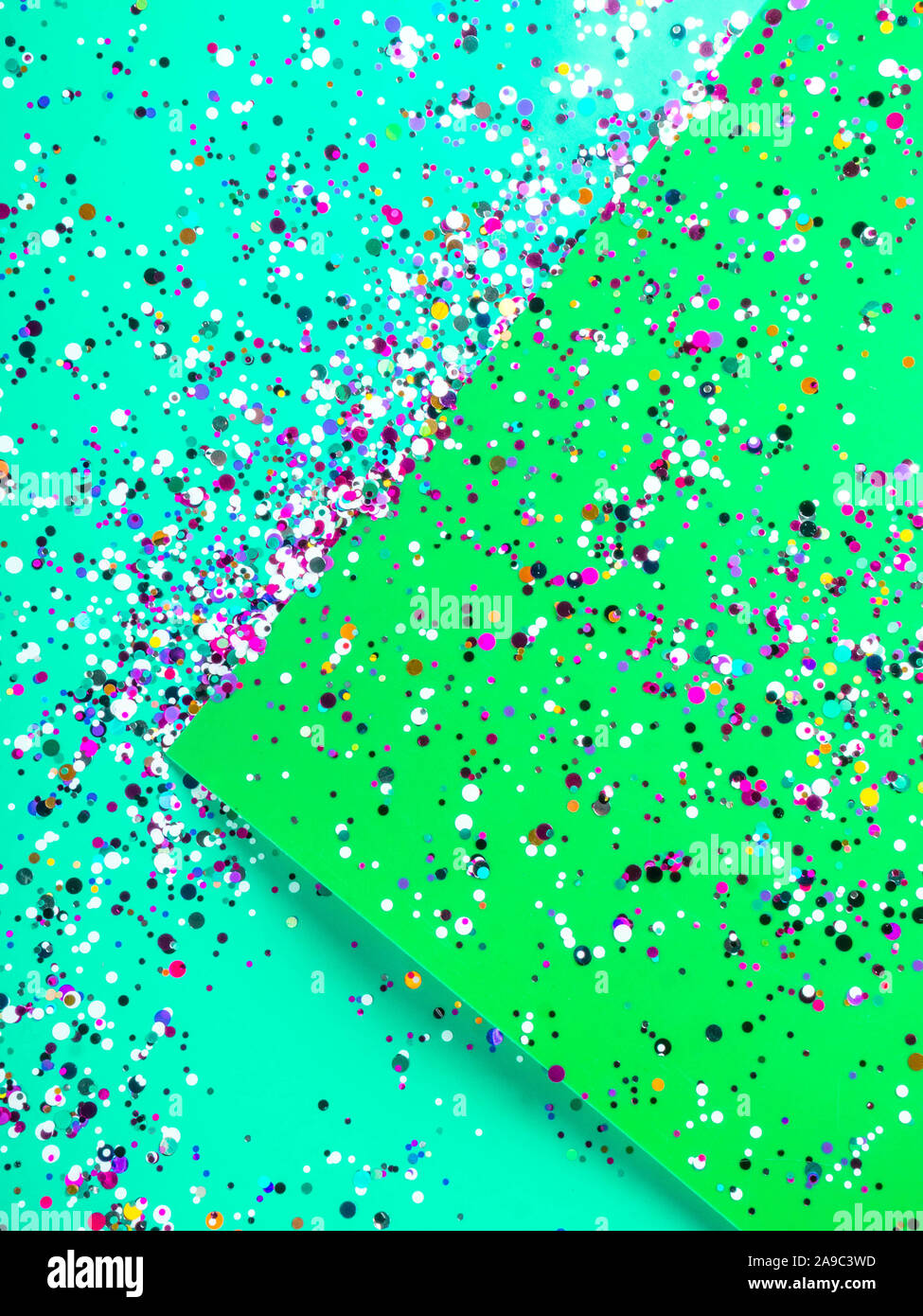 Confetti popper on green and mint green background. Carnival