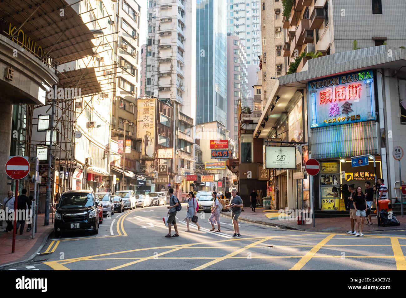 People walk around the junction of Kimberly Road and Observatory Road in Tsim Sha Tsui in Kowloon, Hong Kong. Stock Photo