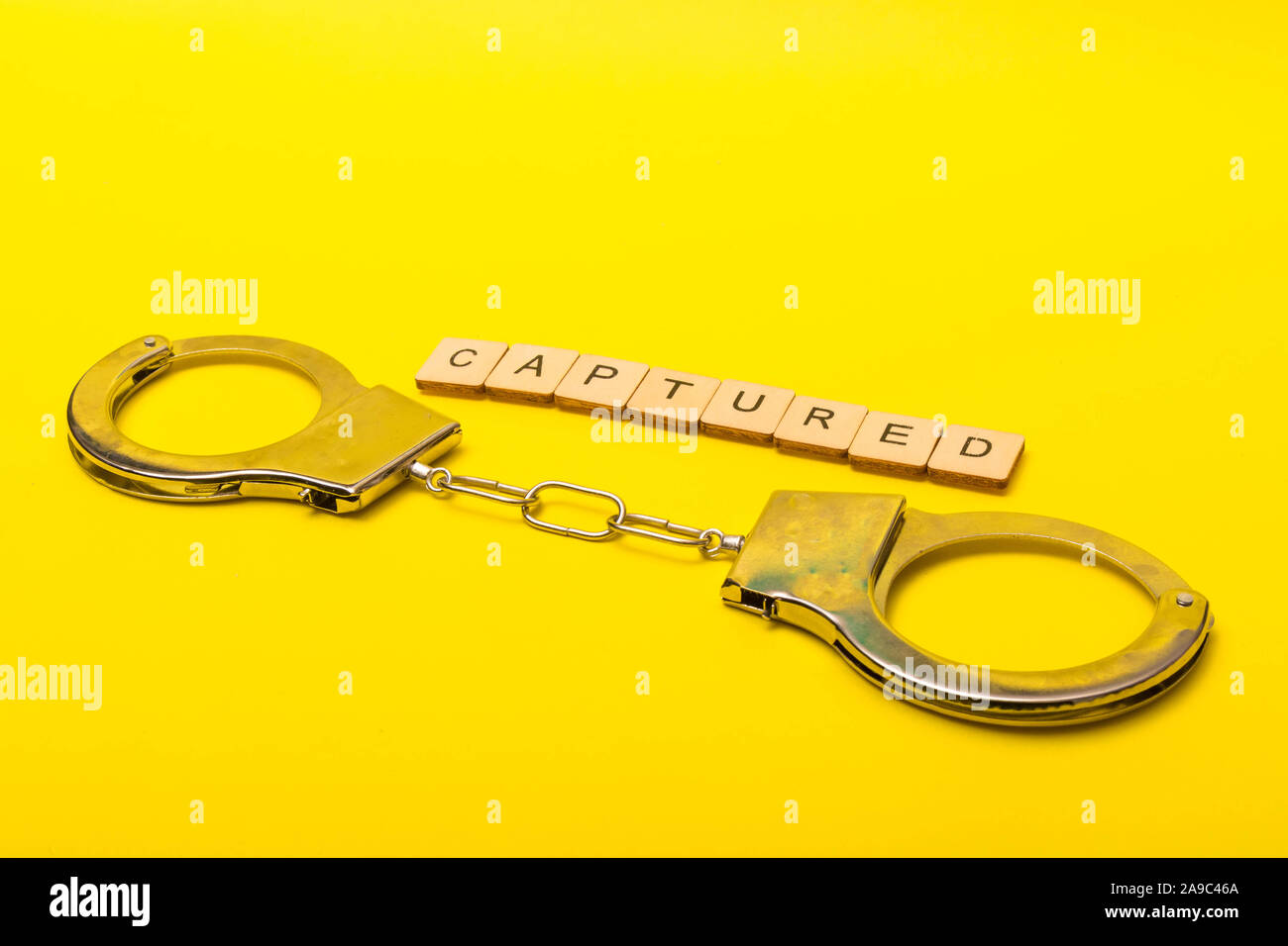 Crime or justice concept showing a sign reading captured on a yellow ...