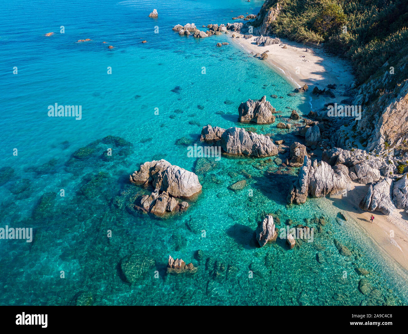 Aerial view of Tropea beach, crystal clear water and rocks that appear ...