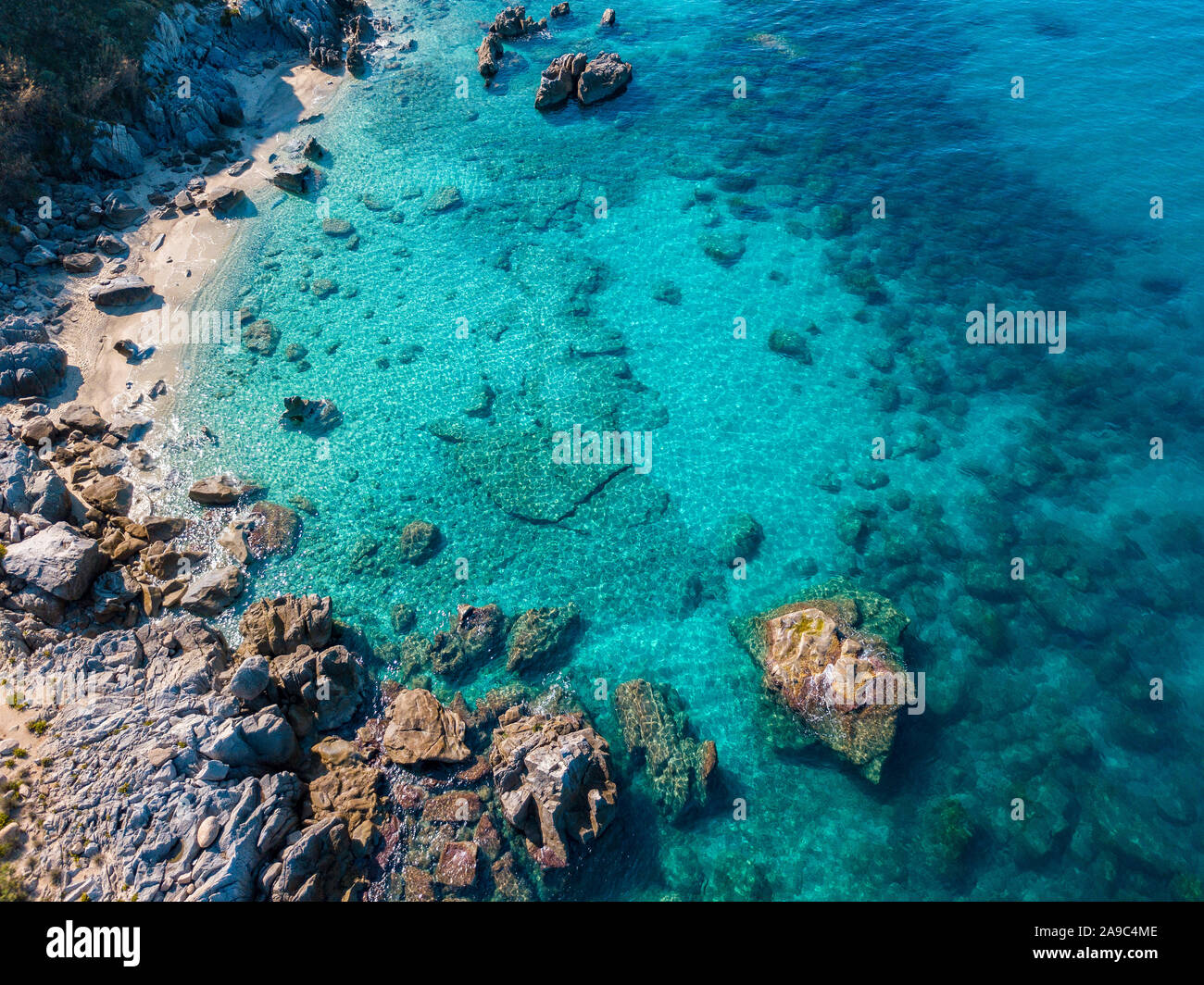 Aerial view of Tropea beach, crystal clear water and rocks that appear ...