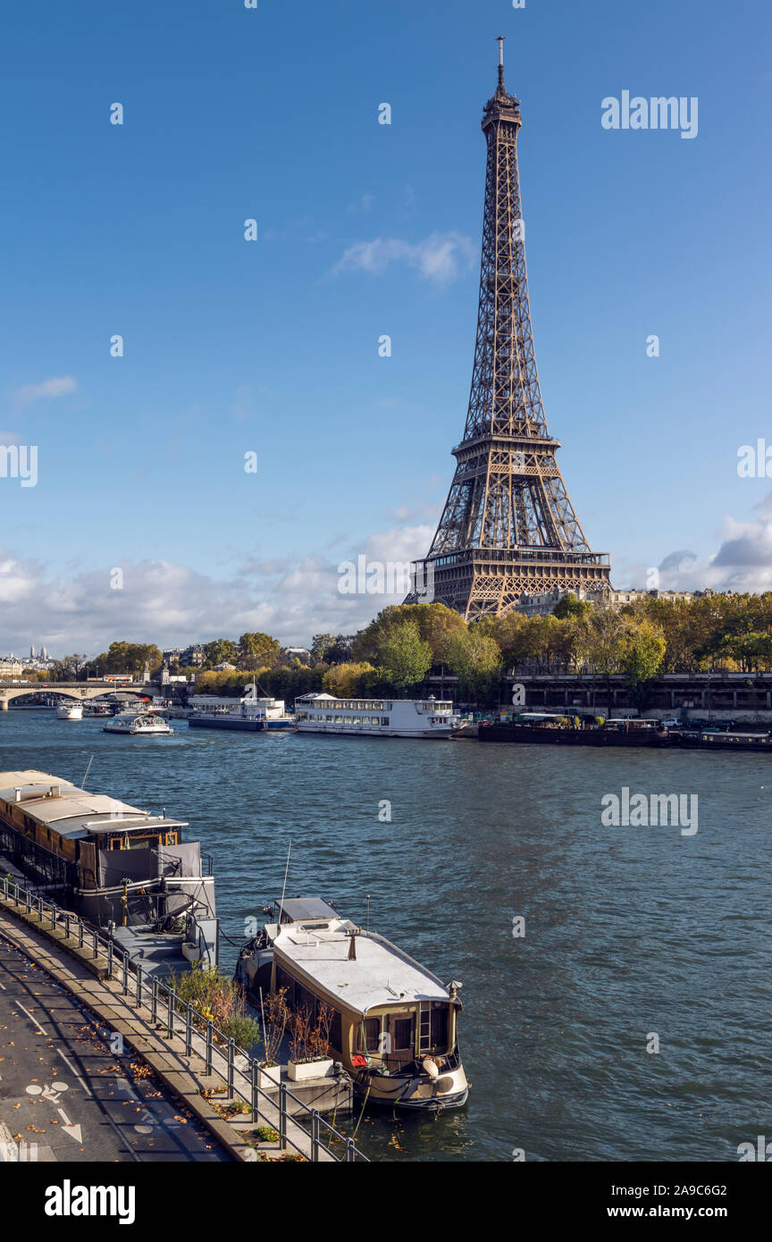 Eiffel tower across Seine River, in foreground are parked boats Stock Photo