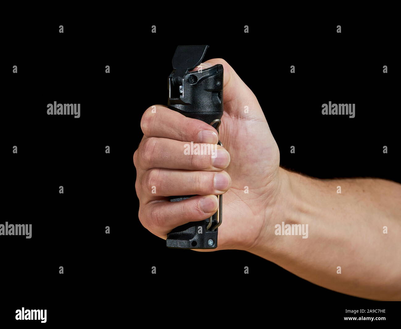 male aiming pepper spray on black background Stock Photo