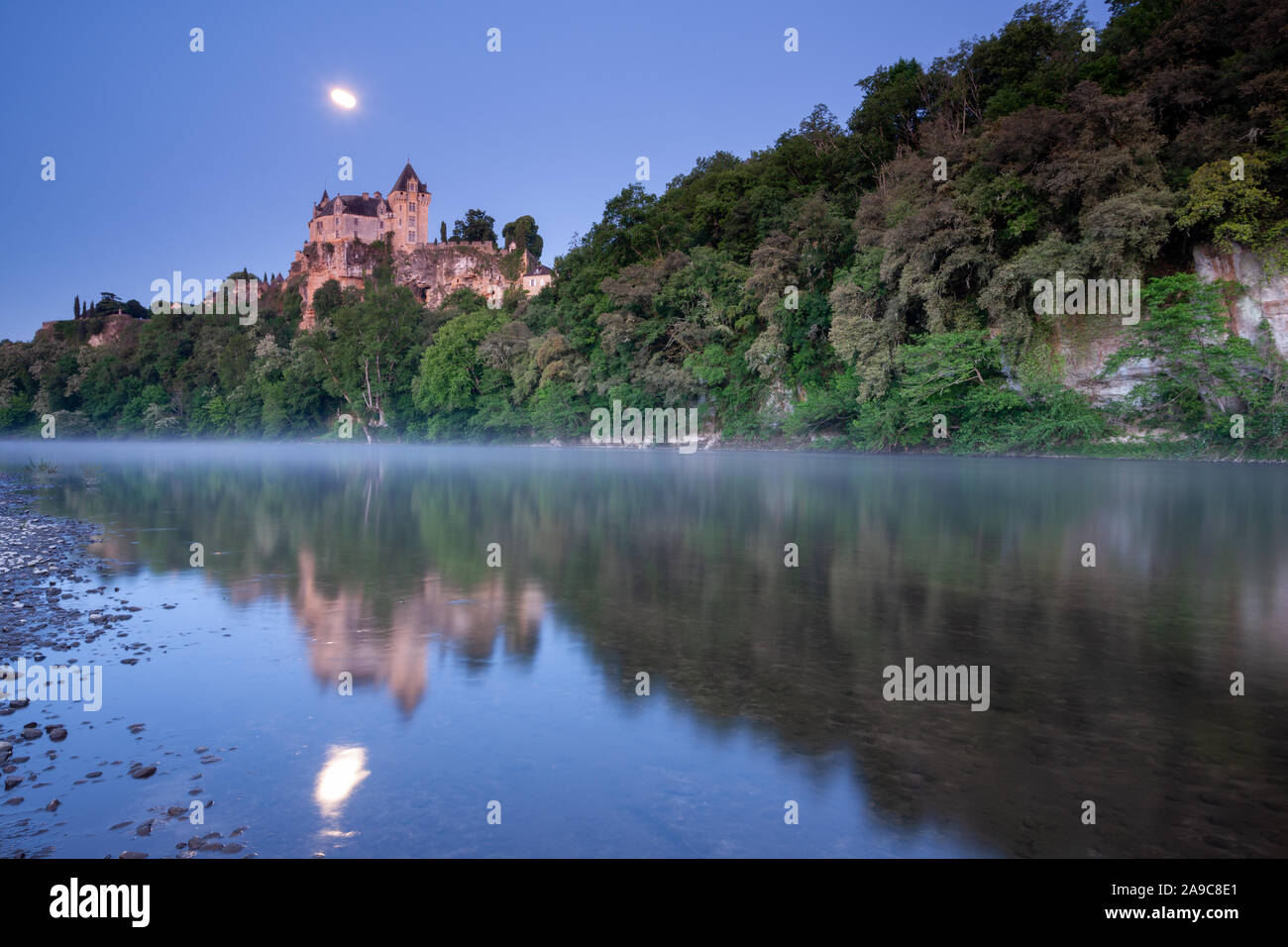Chateau Monfort at sunrise and moonlight, France, Dordogne Stock Photo