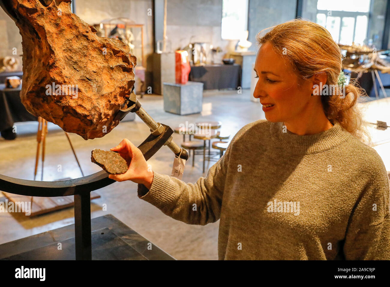 Stane Street, Billingshurst. 14th November 2019. A set of very rare artefacts for sale at Summer's Place Auctions in Billingshurst, West Sussex, as part of their ‘Evolution' collection. Lindsay Hoadley of Summer's Place Auctions Ltd poses with a massive Gibeon meteorite piece from Namibia which is expected to fetch between £18000 and £25000 at auction. Credit: james jagger/Alamy Live News Stock Photo