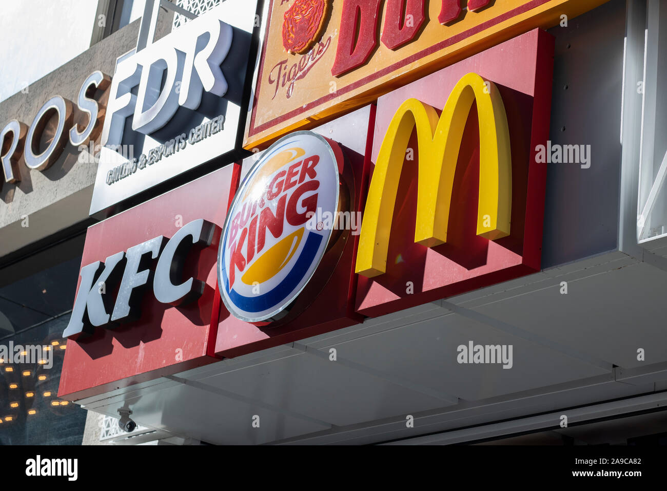 Istiklal, Turkey - October-13,2019: McDonalds, Kfc, Burger King logos hanging on the sign on the wall of the building together. Taken from the sidelin Stock Photo