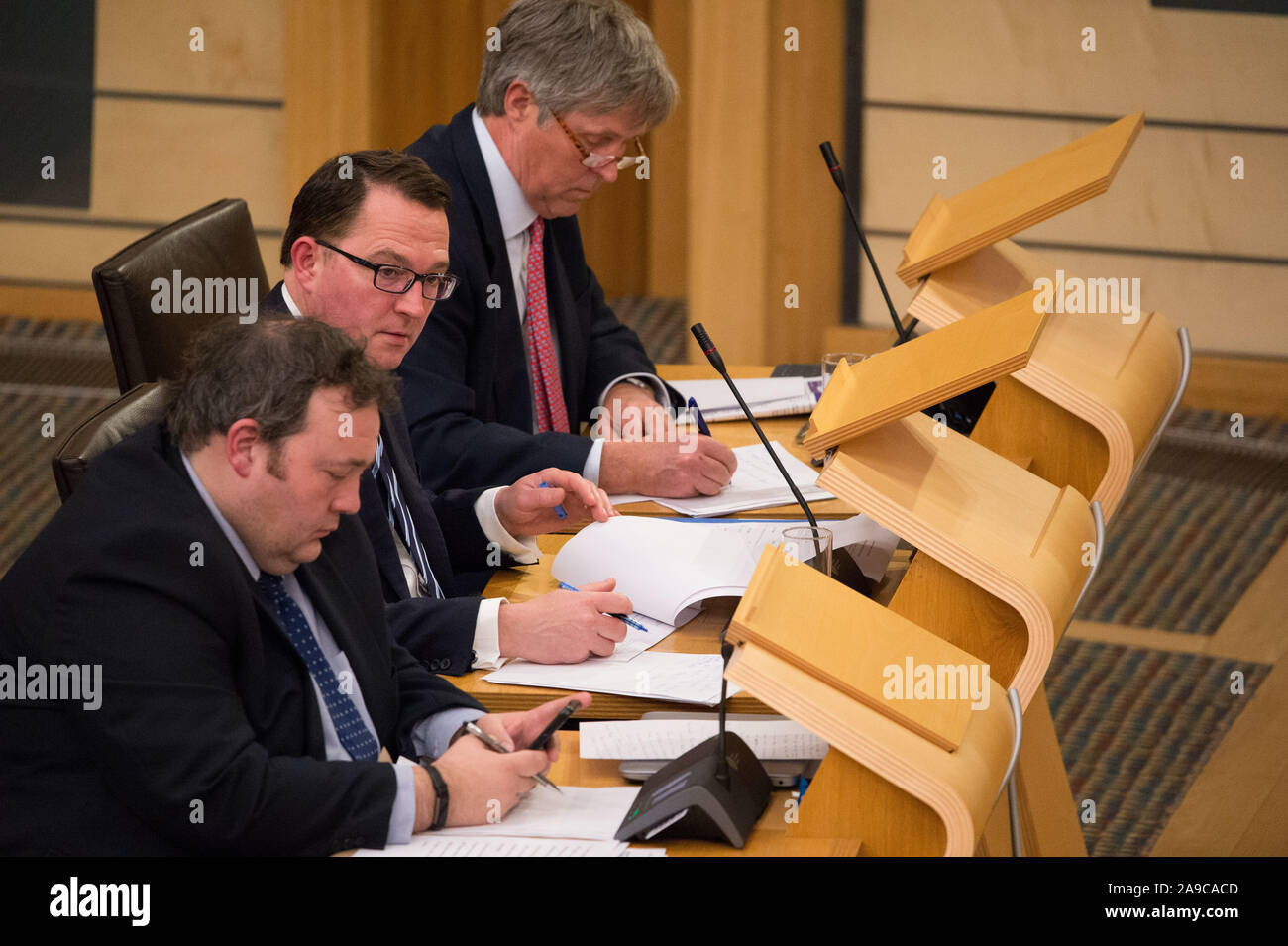 Edinburgh, UK. 14 November 2019.   Pictured:(left-right) Jamie Halcro Johnston - Jobs, Employability and Skills; Dean Lockhart MSP - Shadow Cabinet Secretary for Economy, Jobs and Fair Work; Edward Mountain MSP - Rural Affairs and the Islands. Afternoon debate: Implications of the Imposition of US Tariffs on Scottish Products. Stock Photo