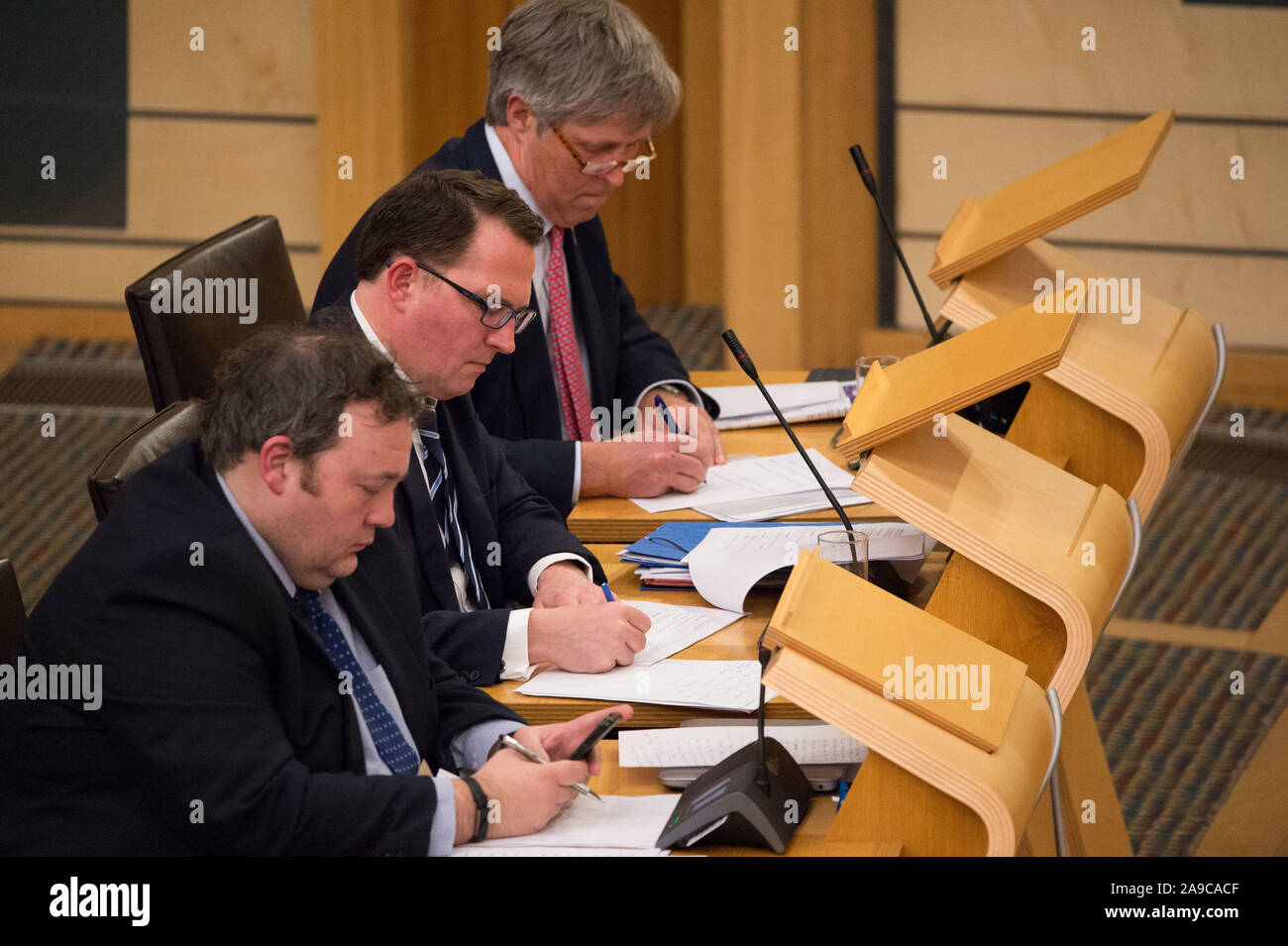 Edinburgh, UK. 14 November 2019.   Pictured:(left-right) Jamie Halcro Johnston - Jobs, Employability and Skills; Dean Lockhart MSP - Shadow Cabinet Secretary for Economy, Jobs and Fair Work; Edward Mountain MSP - Rural Affairs and the Islands. Afternoon debate: Implications of the Imposition of US Tariffs on Scottish Products. Stock Photo