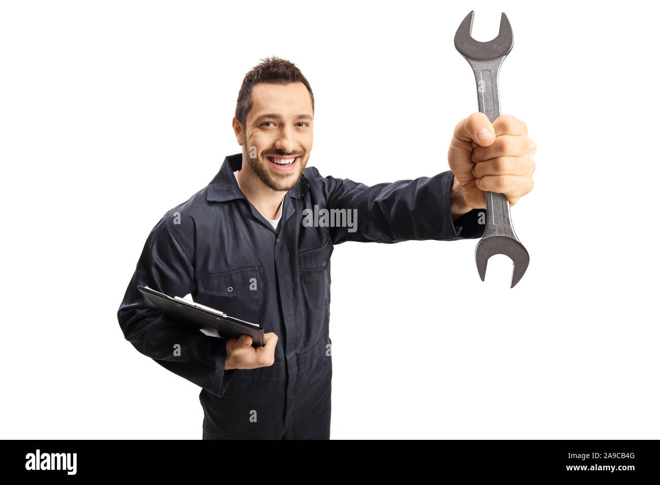 Auto mechanic holding a wrench and a clipboard and smiling at the camera isolated on white background Stock Photo