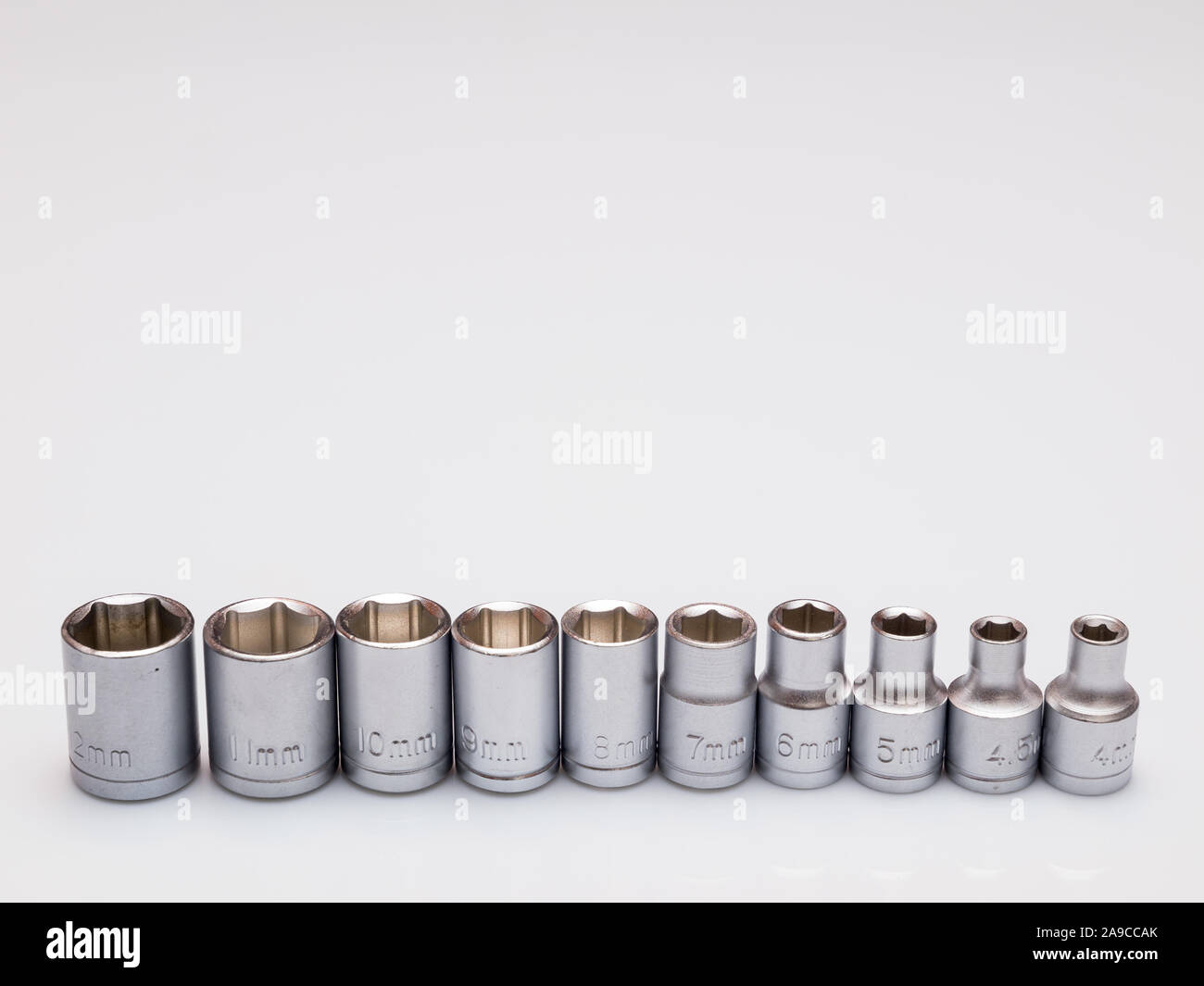set of interchangeable heads for chrome socket wrench. Isolated on white background. Stock Photo