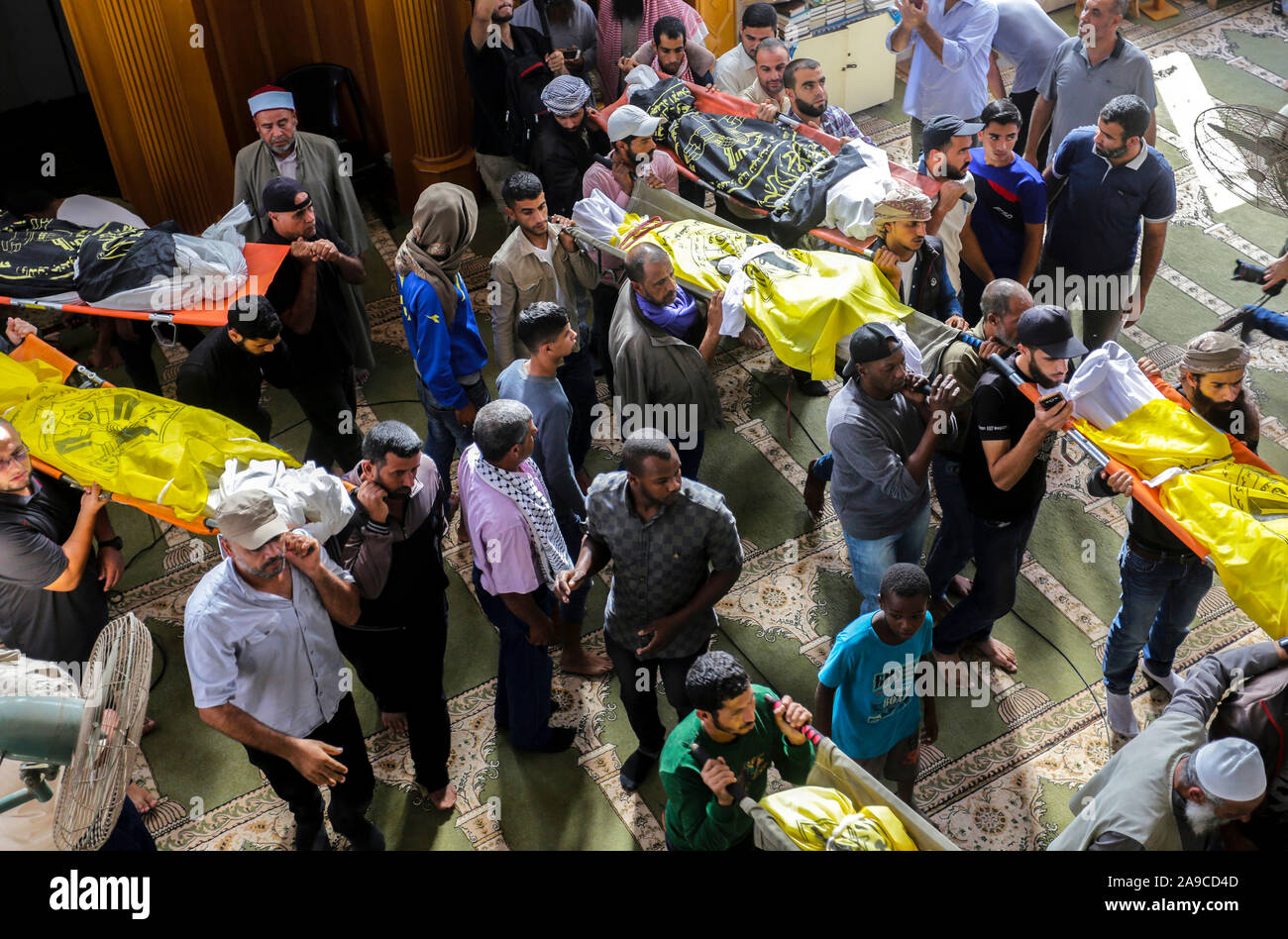 (EDITOR’S NOTE: Image depicts death)Palestinian mourners carry out the bodies of Rasmi Abu Malhous and seven members of his family during their funeral at a mosque in Deir al-Balah, central Gaza Strip. The deceased were killed in an overnight Israeli missile strike that targeted their house. Stock Photo