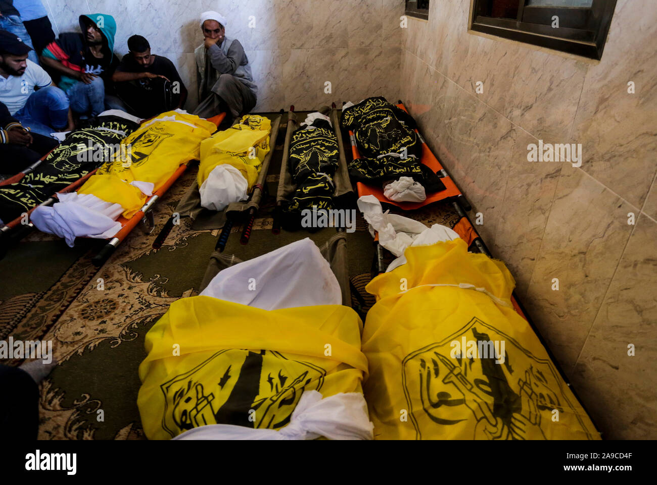 (EDITOR’S NOTE: Image depicts death)Palestinian mourners next to the bodies of Rasmi Abu Malhous and seven members of his family during their funeral at a mosque in Deir al-Balah, central Gaza Strip. The deceased were killed in an overnight Israeli missile strike that targeted their house. Stock Photo