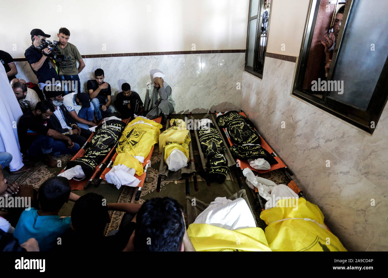 (EDITOR’S NOTE: Image depicts death)Palestinian mourners next to the bodies of Rasmi Abu Malhous and seven members of his family during their funeral at a mosque in Deir al-Balah, central Gaza Strip. The deceased were killed in an overnight Israeli missile strike that targeted their house. Stock Photo