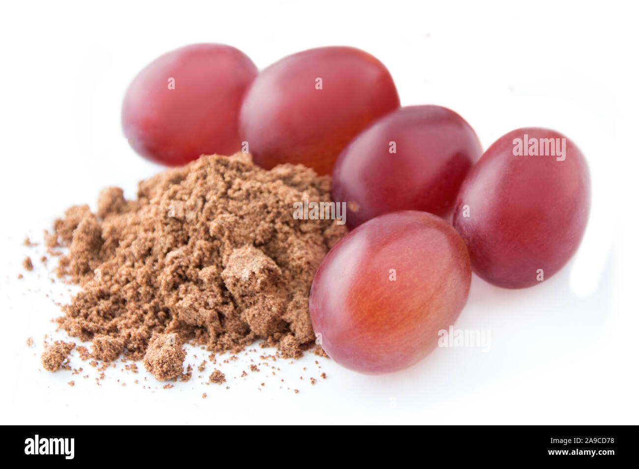Grape seed powder and grapes Stock Photo