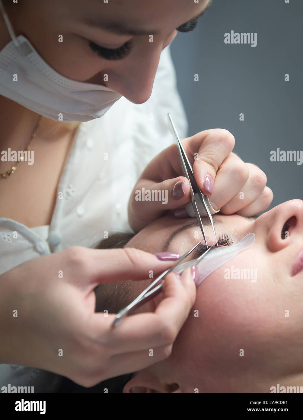 Woman getting a beautiful eyelashes extensions Stock Photo