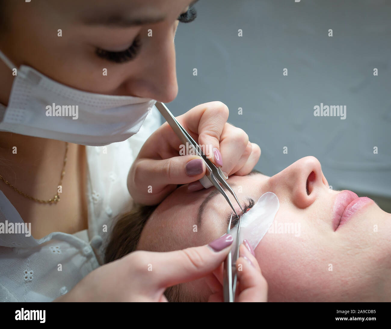 Woman getting a beautiful eyelashes extensions Stock Photo