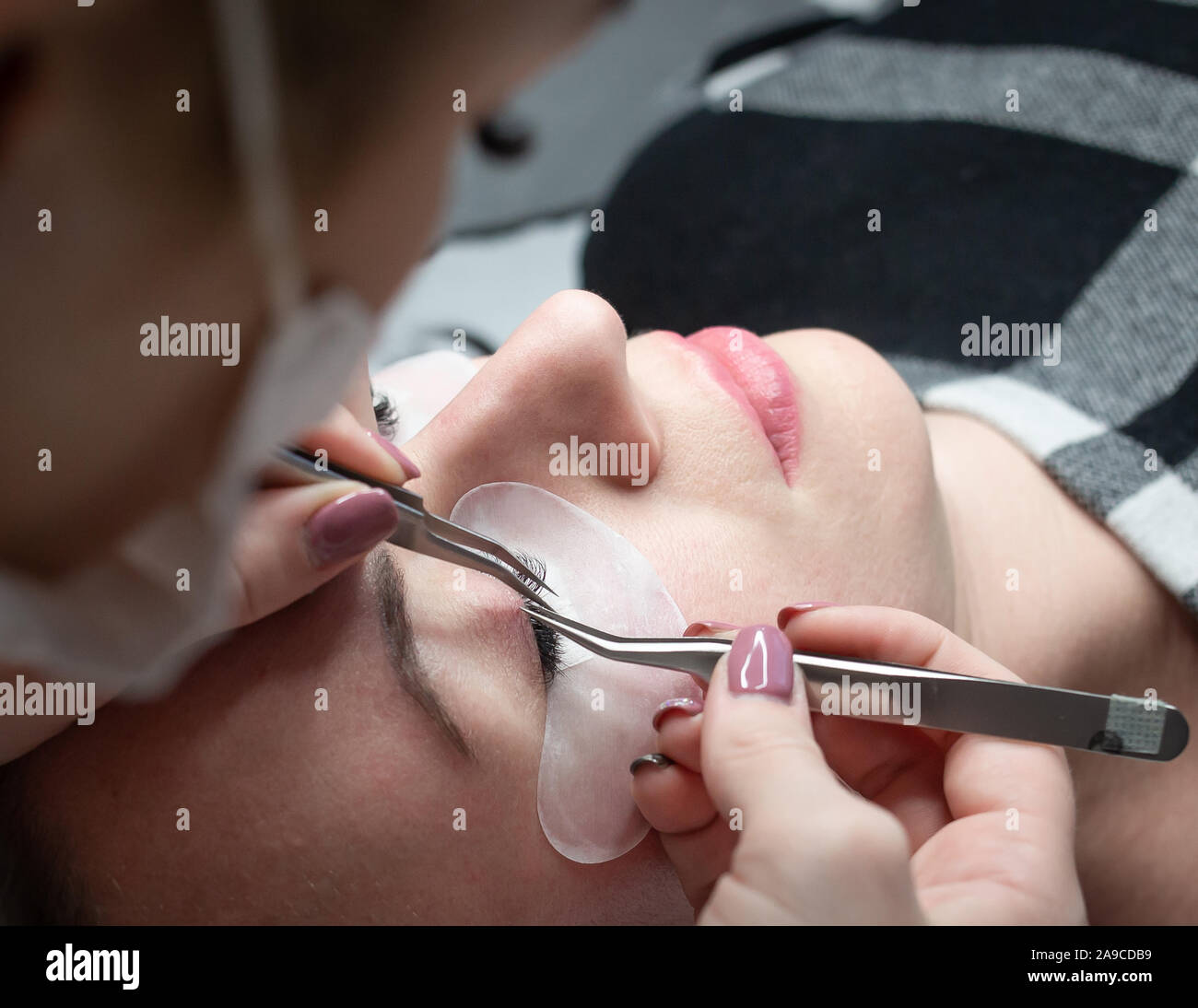 Woman getting a beautiful eyelashes extensions Stock Photo