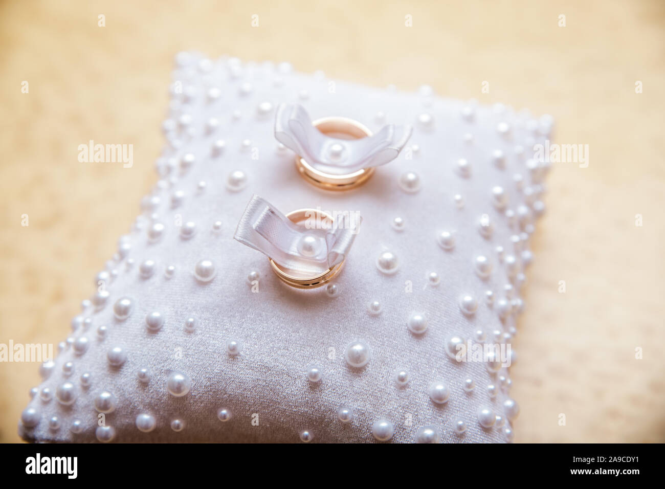 Wedding rings on a white small pillow Stock Photo Alamy