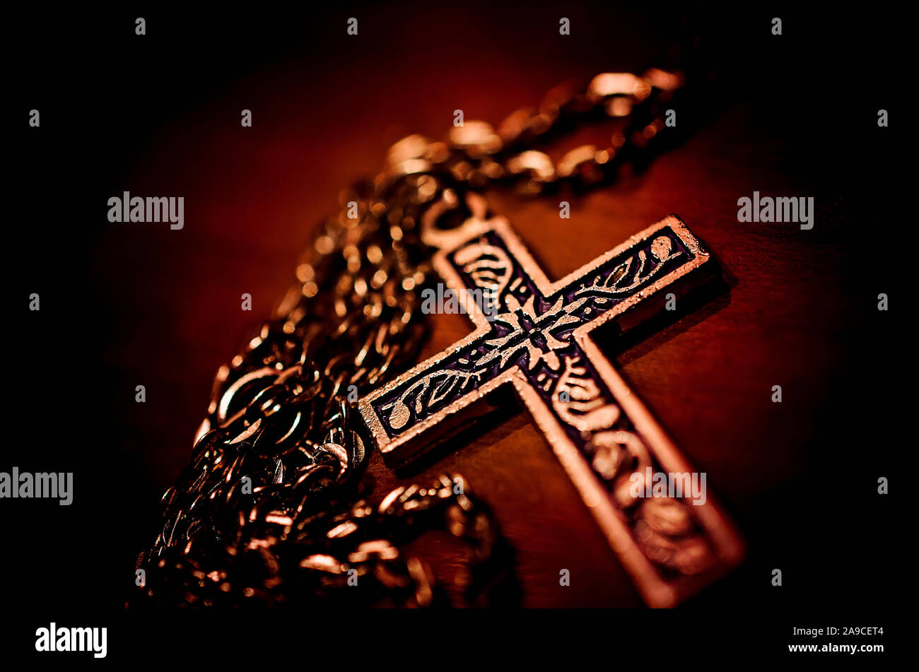 A sterling silver cross lays on a wooden desk, January 2, 2016, in Coden, Alabama. Stock Photo