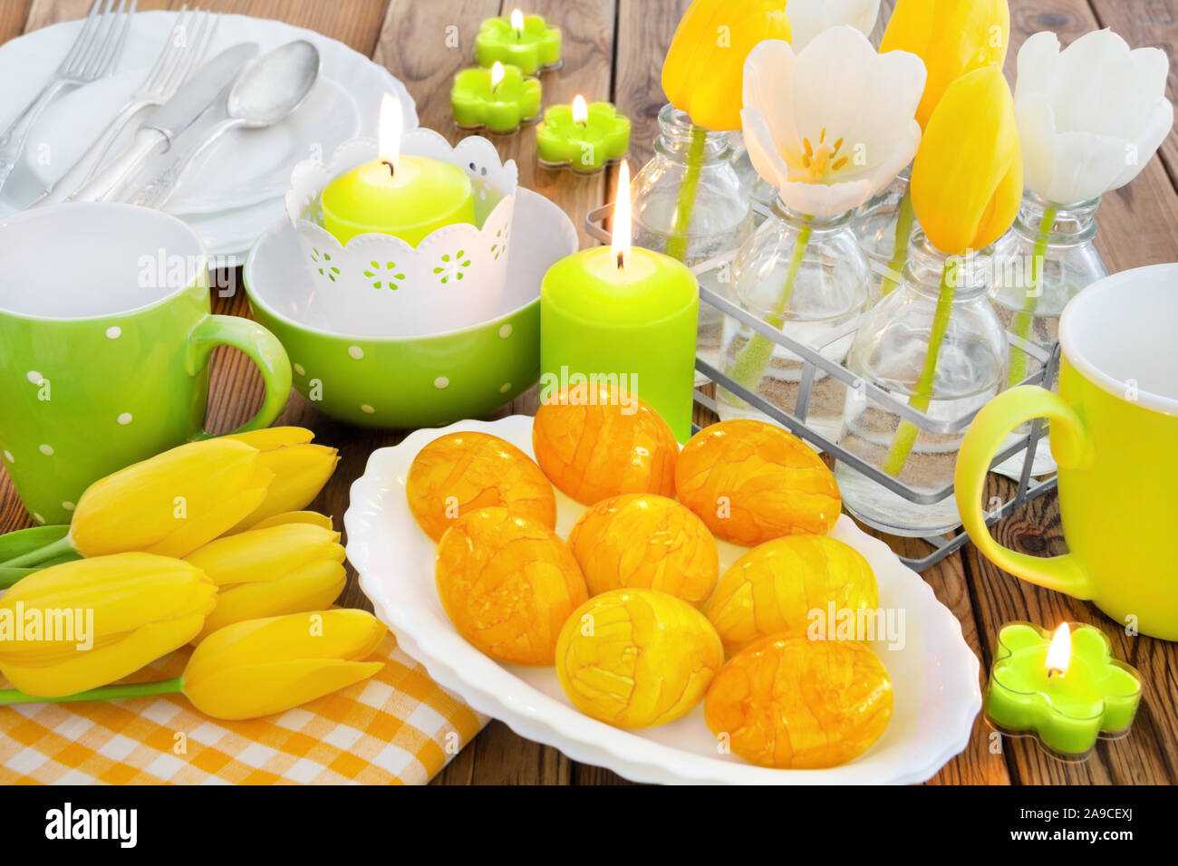 Easter table decorations with eggs and candles Stock Photo