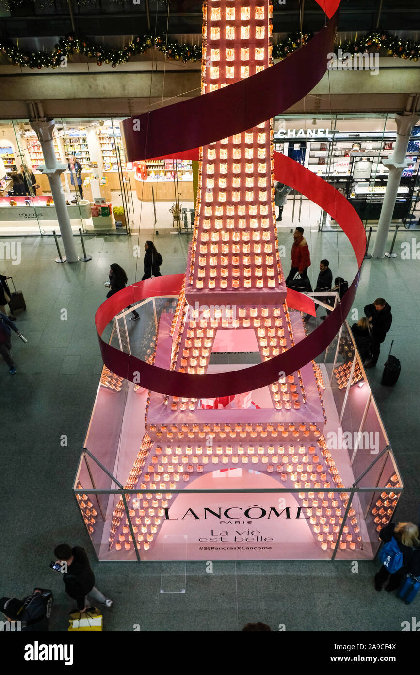 St Pancras Internatinal Station, London, UK. 14th November 2019.   Lancôme 36 foot high Eiffel Tower in St Pancras station, made up of more than 1,500 bottles of the La Vie Est Belle fragrance. The bottles will then be donated to the cancer charity Look Good Feel Better. Credit: Matthew Chattle/Alamy Live News Stock Photo