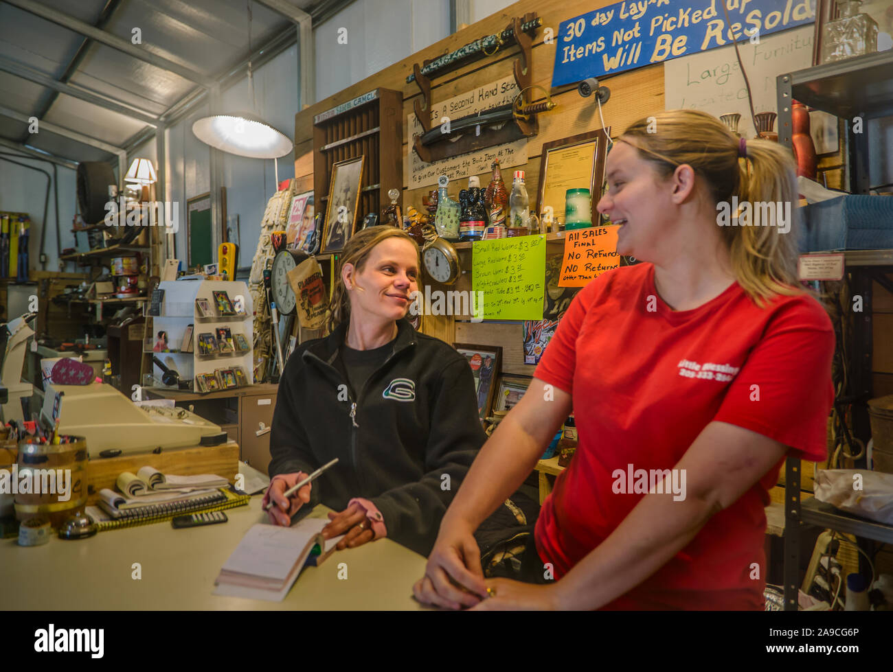 A woman jokes with her stepdaughter as they work the counter at The Mud Hole, March 18, 2014, in Reform, Alabama. Stock Photo