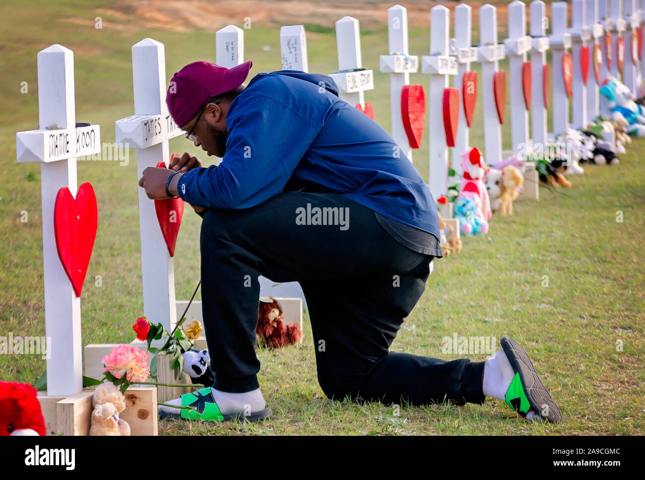 Terry Freeman leaves a message on a cross for tornado victim James Tate at Providence Baptist Church, March 7, 2019, in Opelika, Alabama. Stock Photo