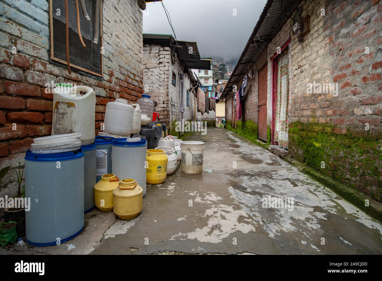 The difficulties of Shimla's residents in accessing clean drinking water is made explicit by these plastic containers outside the home Stock Photo