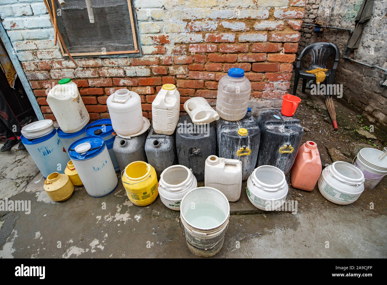 The difficulties of Shimla's residents in accessing clean drinking water is made explicit by these plastic containers outside the home Stock Photo