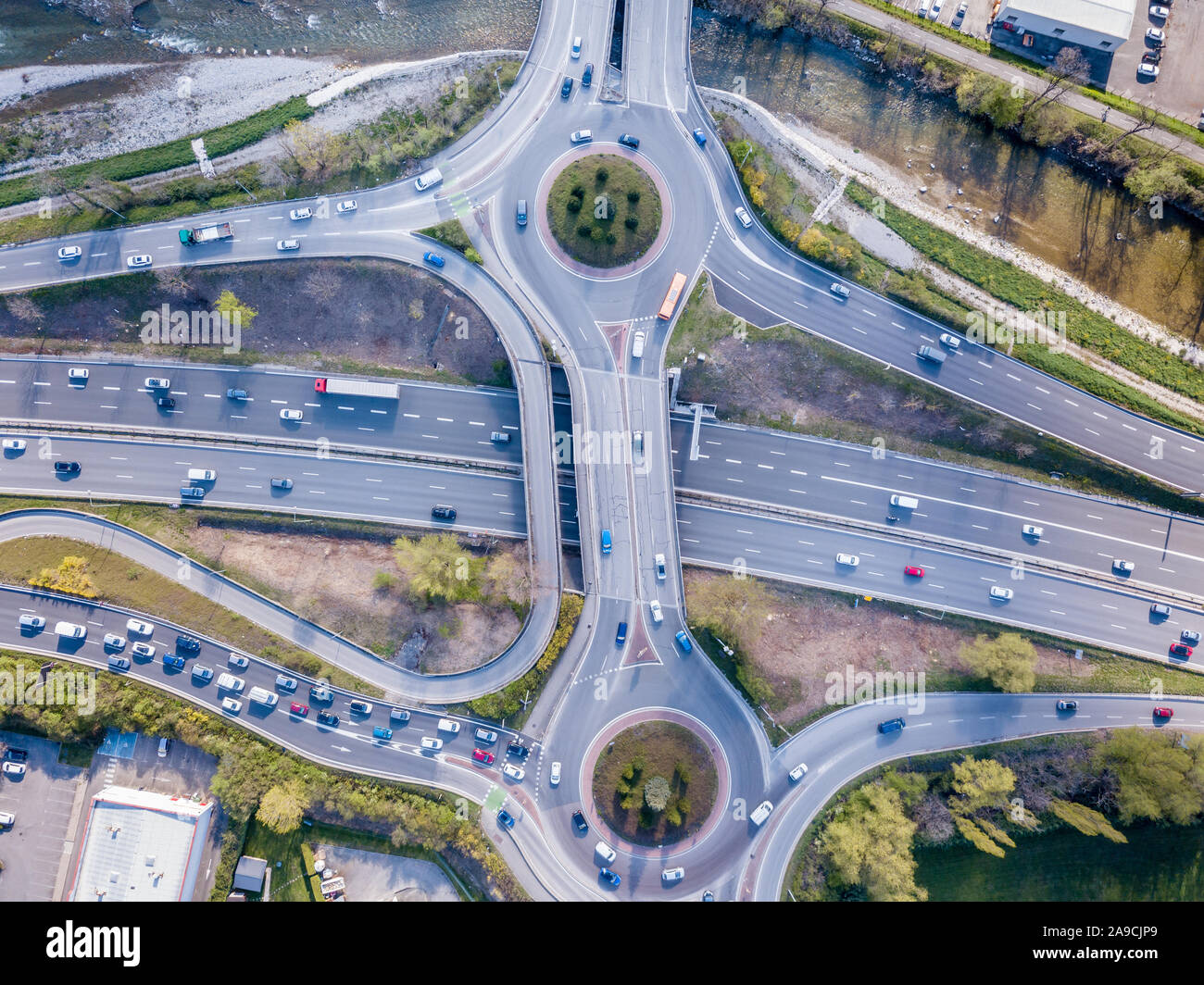 Highway interchange junction with traffic aerial top down view photography from drone with vehicles driving on freeway, roundabout and ramp lanes, tra Stock Photo