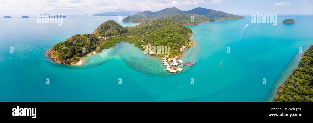 Tropical landscape aerial panorama with island coastline and beaches surrounded by transparent blue sea water, green rainforest, panoramic view from d Stock Photo