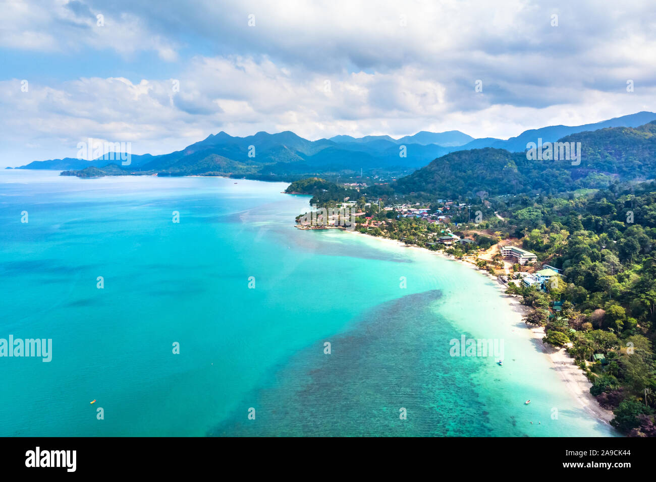 Aerial view of tropical island beach and coastline with transparent turquoise sea water and rainforest landscape, vacation holidays destination with t Stock Photo