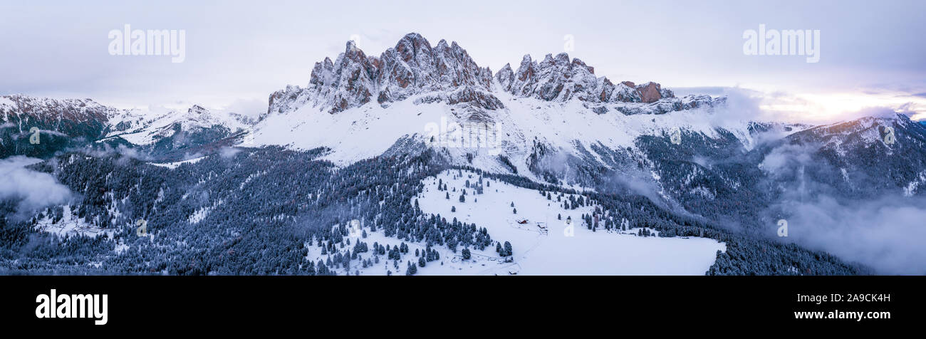 Scenic winter mountain landscape in Alps with aerial panoramic view of Geisler Peaks from Adolf Munkel trail in Zanser Alm, South Tyrol Dolomites with Stock Photo
