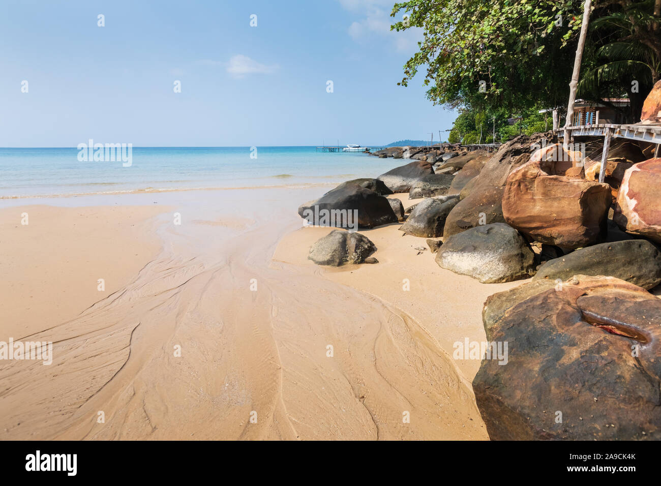 Natural beach on tropical paradise island for summer vacation holidays, stones, sand and turquoise sea water Stock Photo