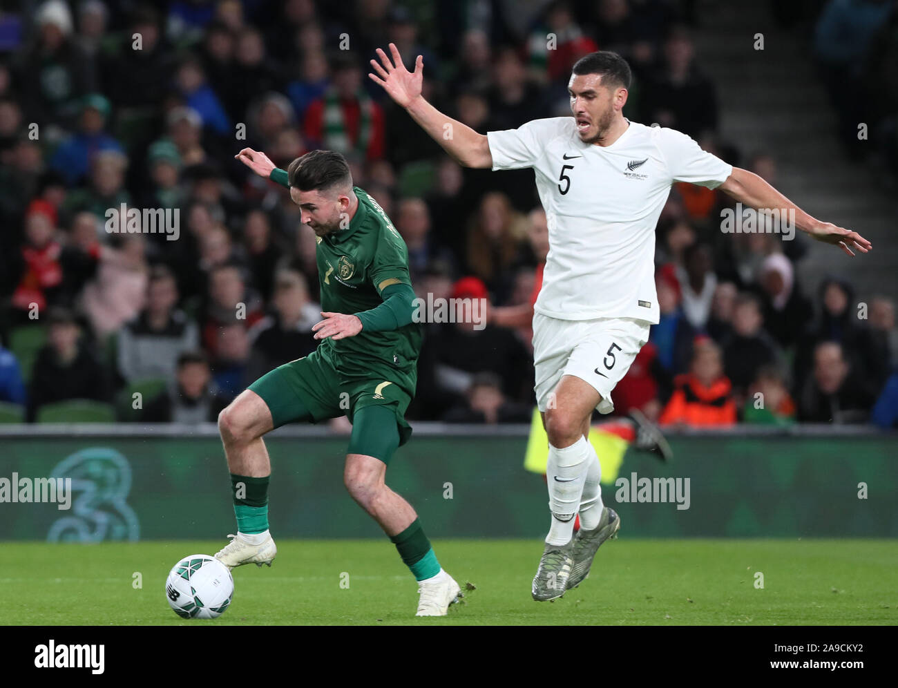 Republic of Ireland's Sean Maguire (left) and New Zealand's Michael Boxall battle for the ball during the International Friendly at the Aviva Stadium, Dublin. Stock Photo