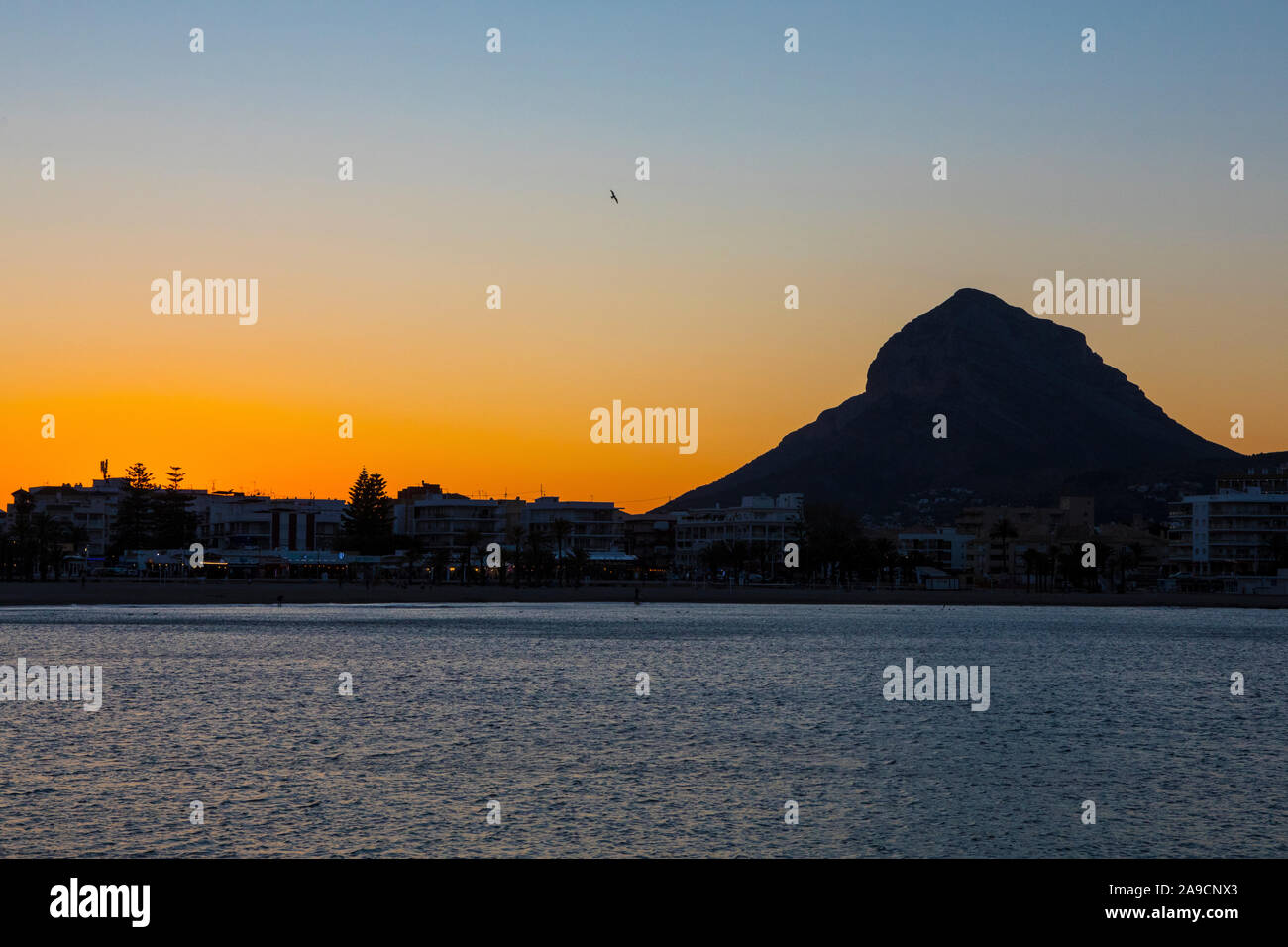 Javea, Spain - April 14th 2019: A sunset view of the mountain Montgo Massif in the beautiful coastal town of Javea in Spain. Stock Photo