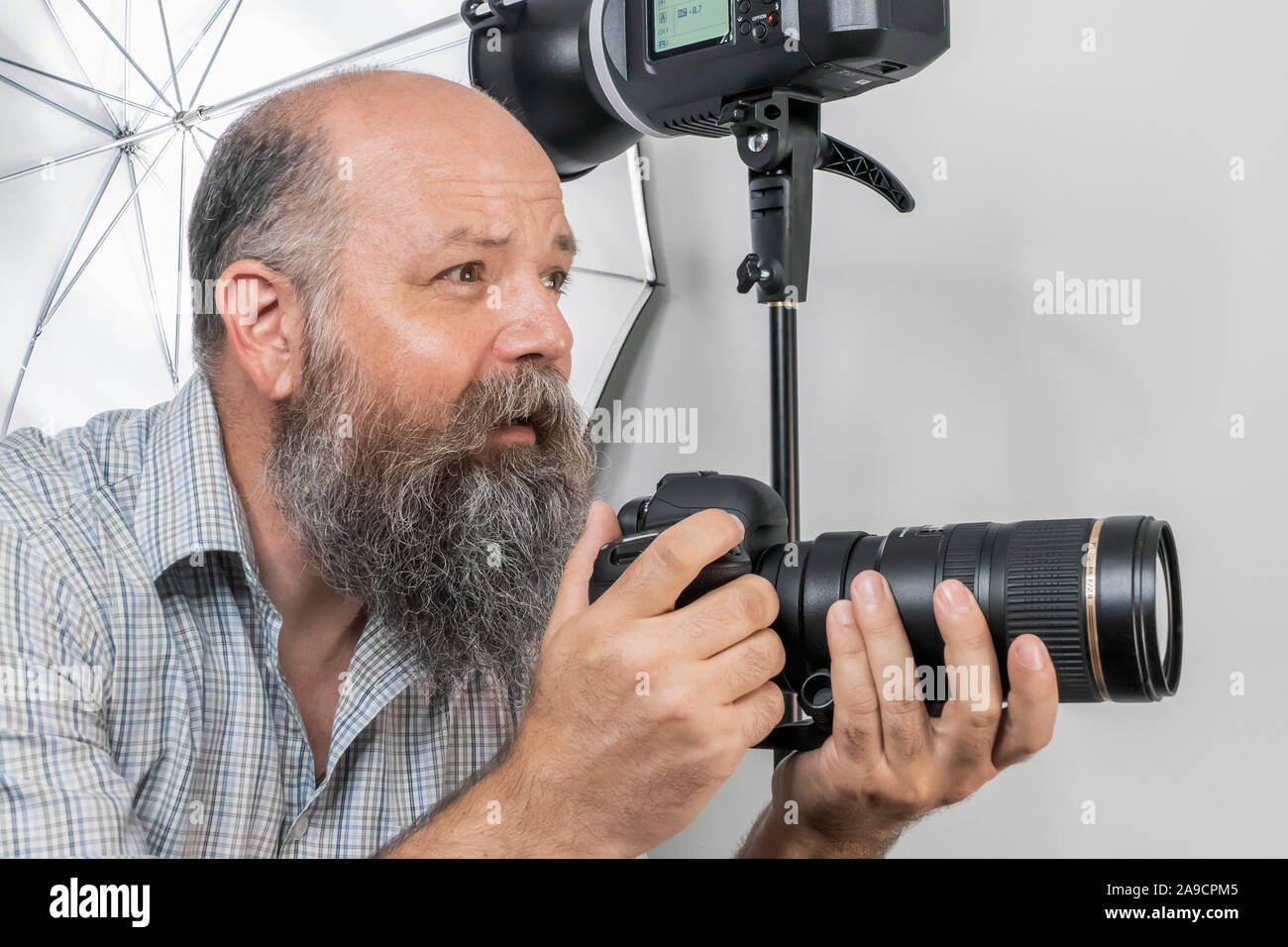 An image of a bearded senior photographer at work Stock Photo