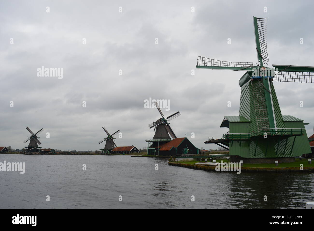 Zaandam, Netherlands. 11 November, 2019. Historic Dutch windmills in Zaanse Schans along the river of De Zaan. Stock Photo