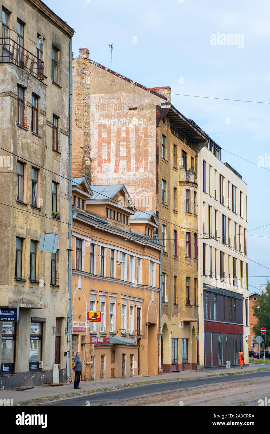 Old buildings with Cyrillic writings, Soviet architecture in Riga, vertical Stock Photo