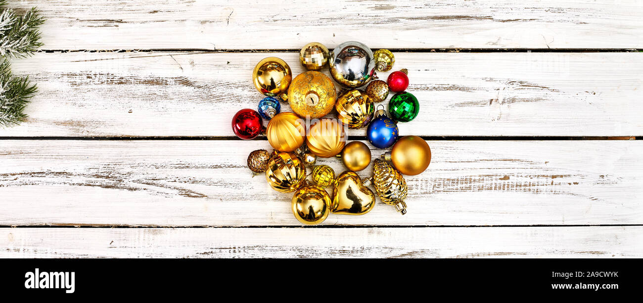 Christmas stack of Xmas balls decorations on white wooden boards Stock Photo