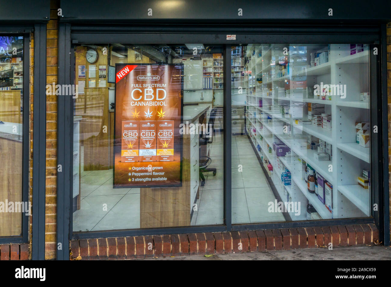 An advertisement for Cannabidiol or CBD in the window of a south London chemist. Stock Photo